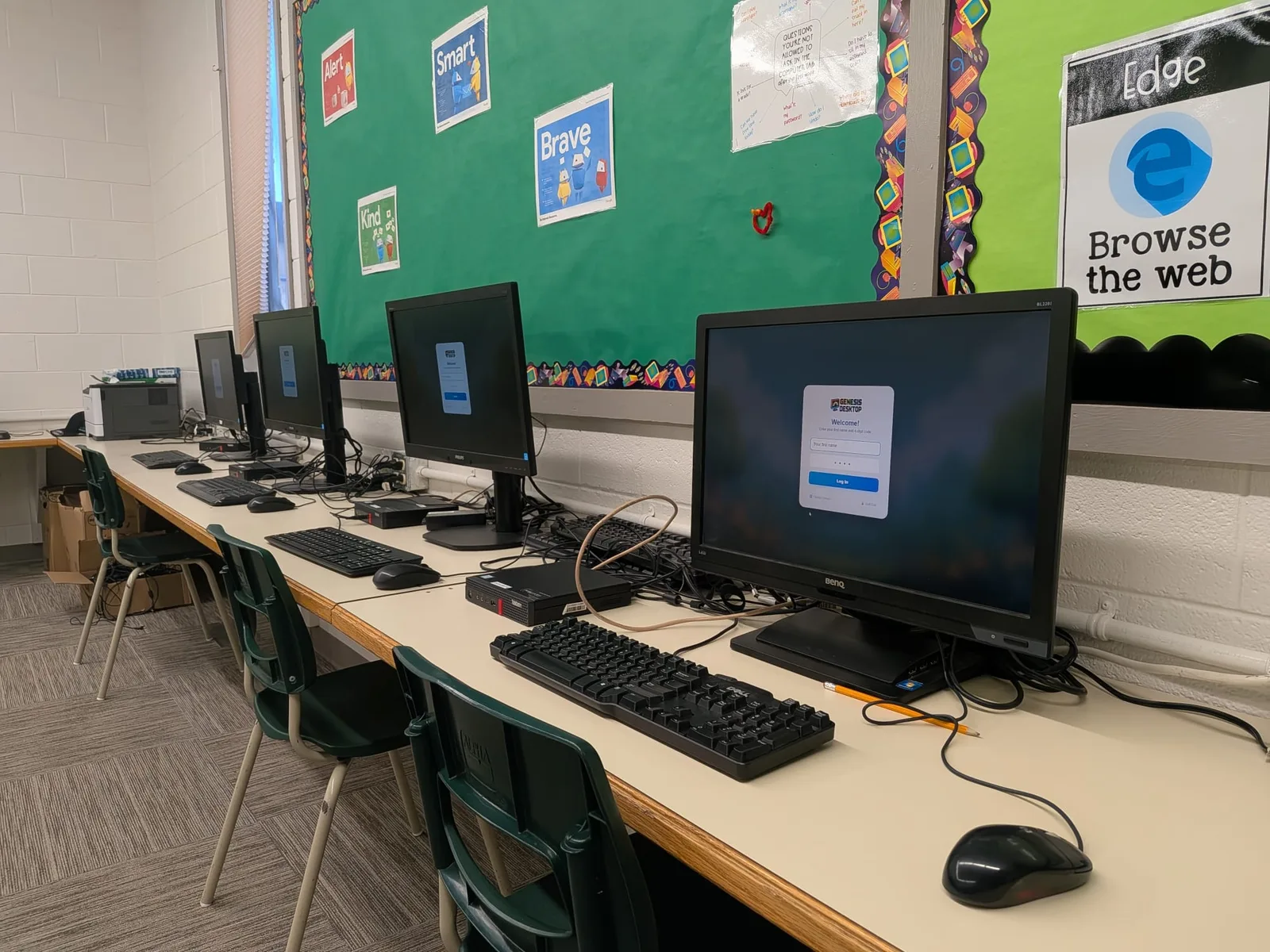 Row of school computers at the Genesis Desktop sign-in screen
